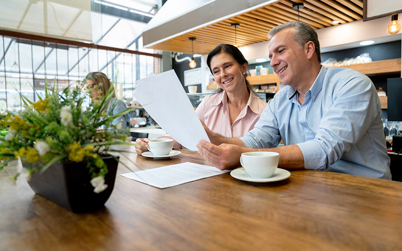 Couple reading forms in a coffee shop 