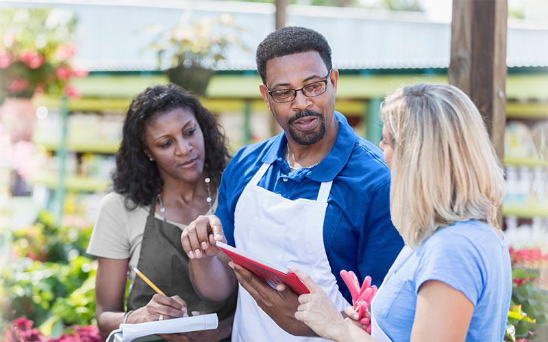 Three employee discussing gardening business 